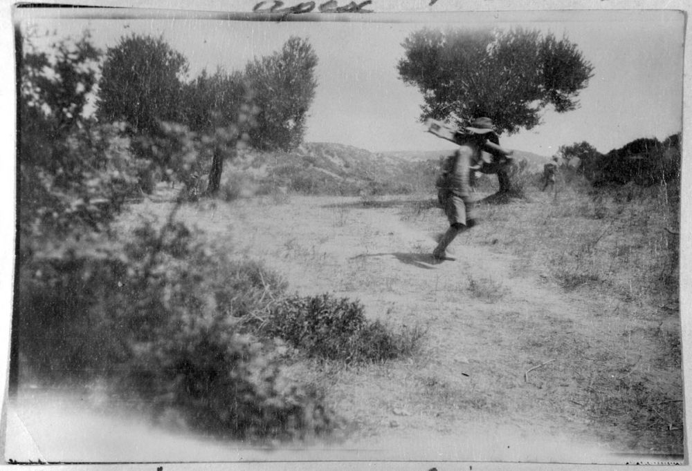 A soldier carrying a machine gun during the advance on Hill 60.
